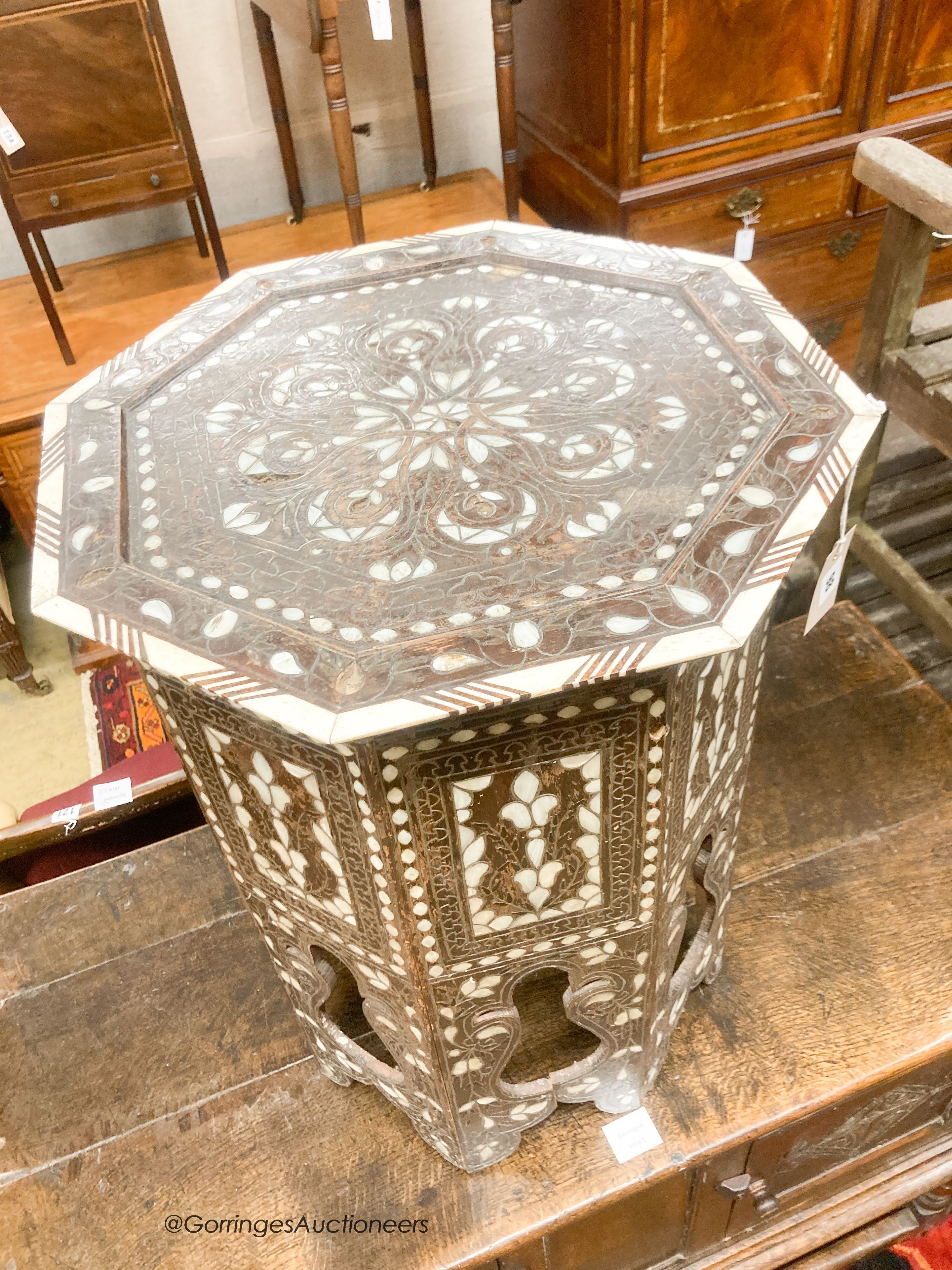 A Middle Eastern mother of pearl and bone inlaid octagonal topped coffee table, width 45cm, height 60cm